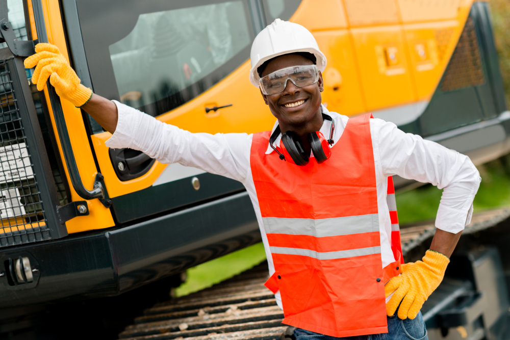 Construction worker with a crane at the background Construction worker with a crane at the background